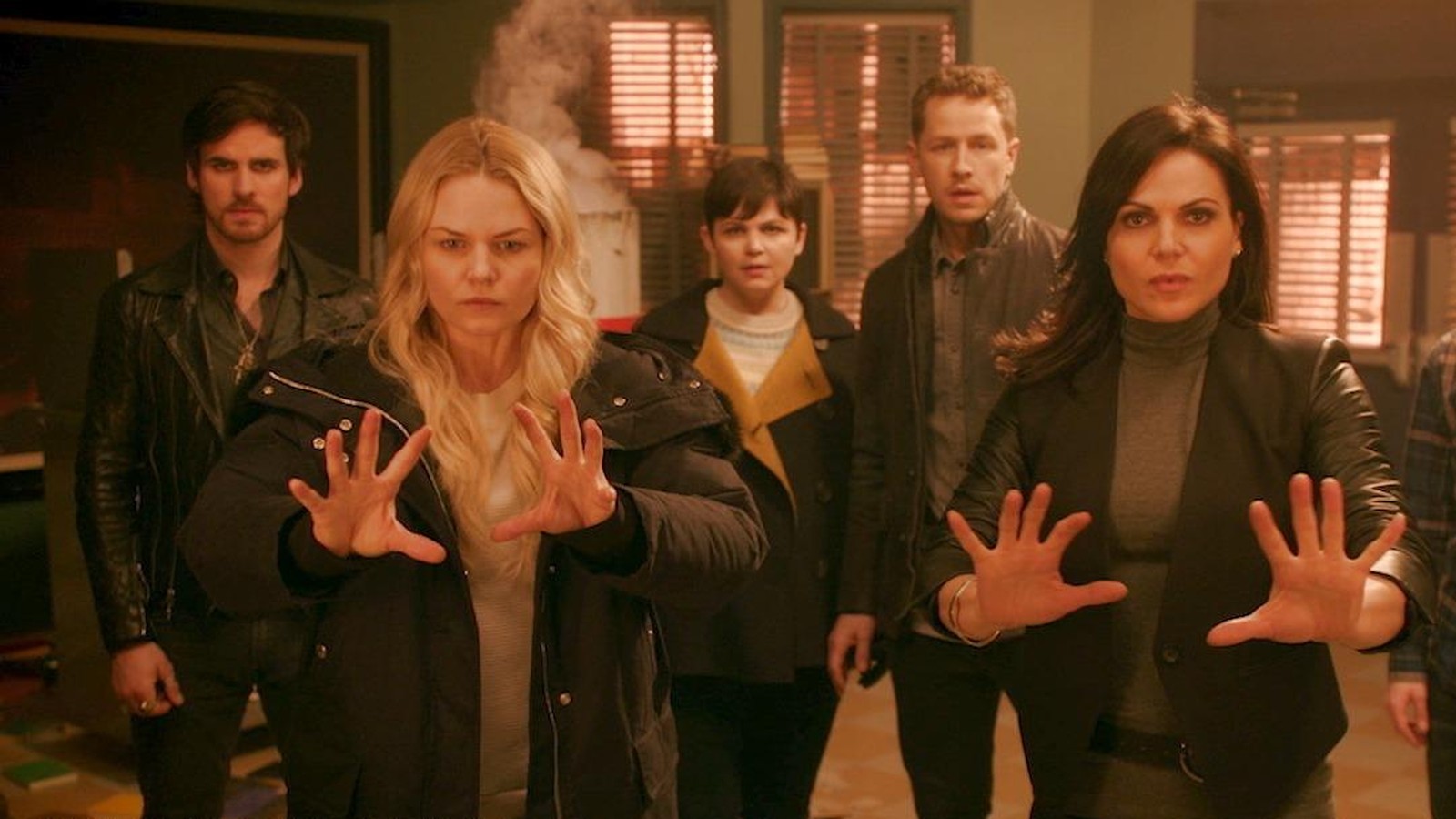 Snow, David, and Hook stand behind Emma and Regina while they use their magic to force an unseen foe away.