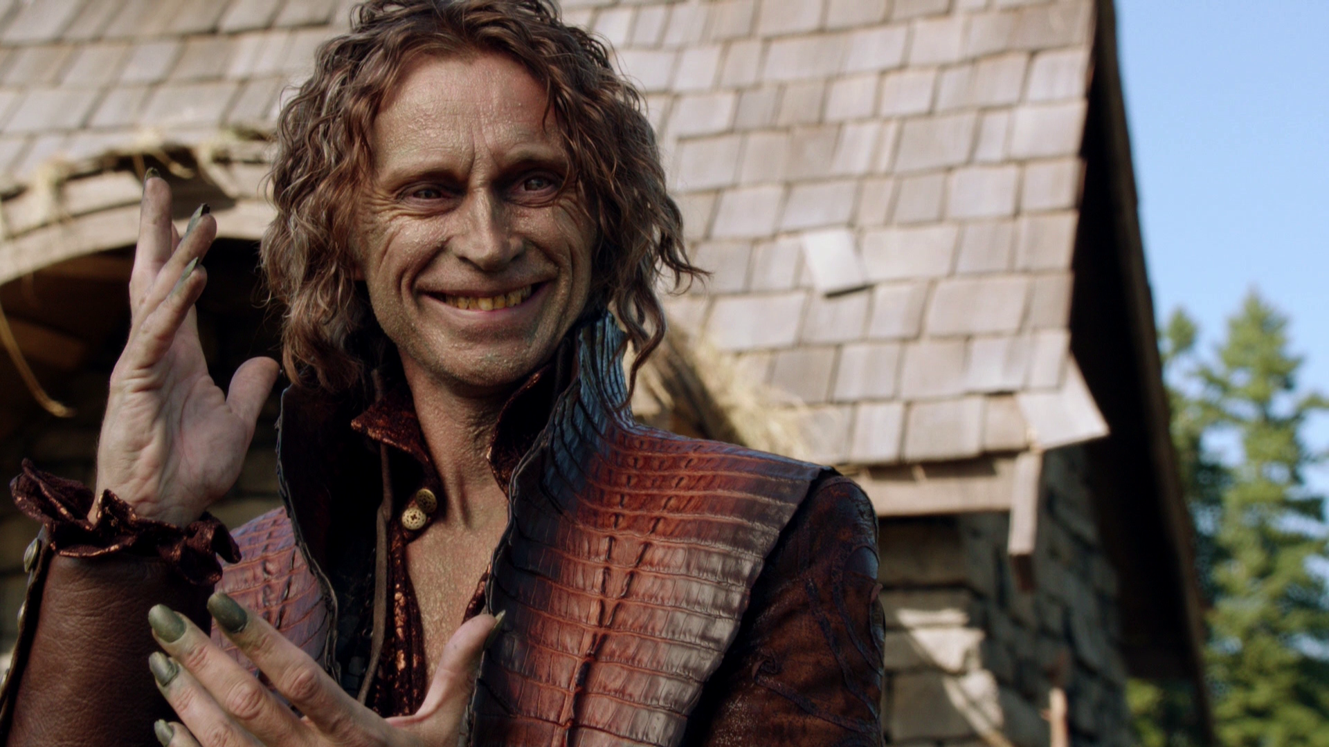 Rumplestiltskin is smirking in a malicious way with his hands gestured in a taunting fashion.