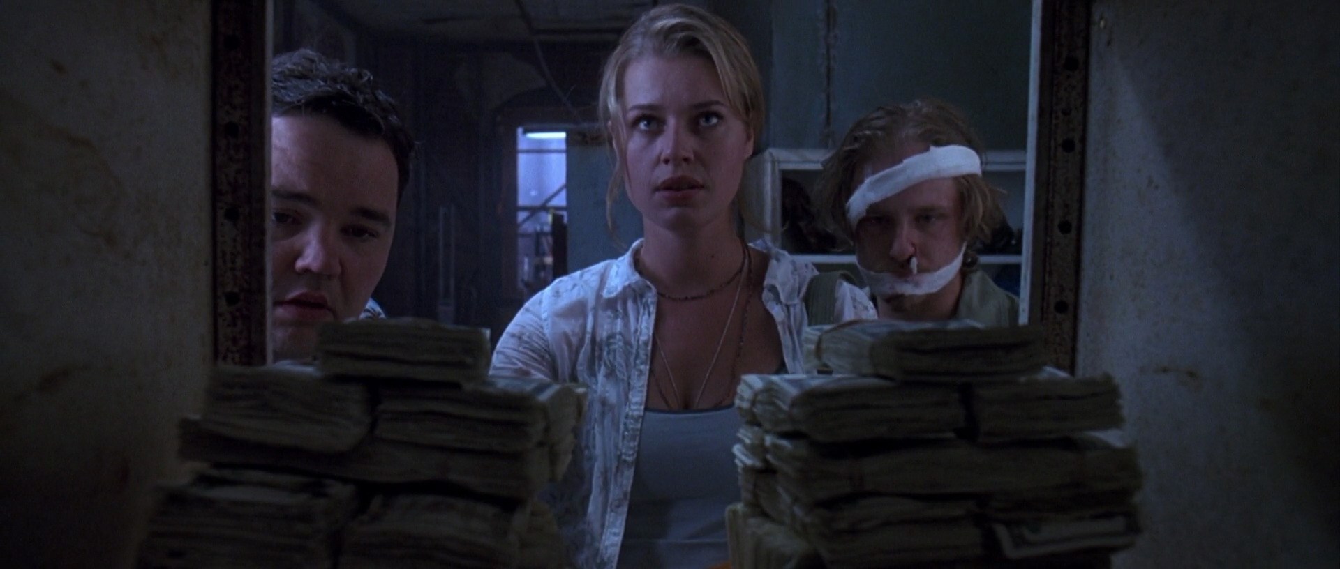 Hensleigh, Jonathan, dir. The Punisher. 2004.
The side-characters of The Punisher gaze at a pile of money Frank has left for them after defeating Howard Saint.