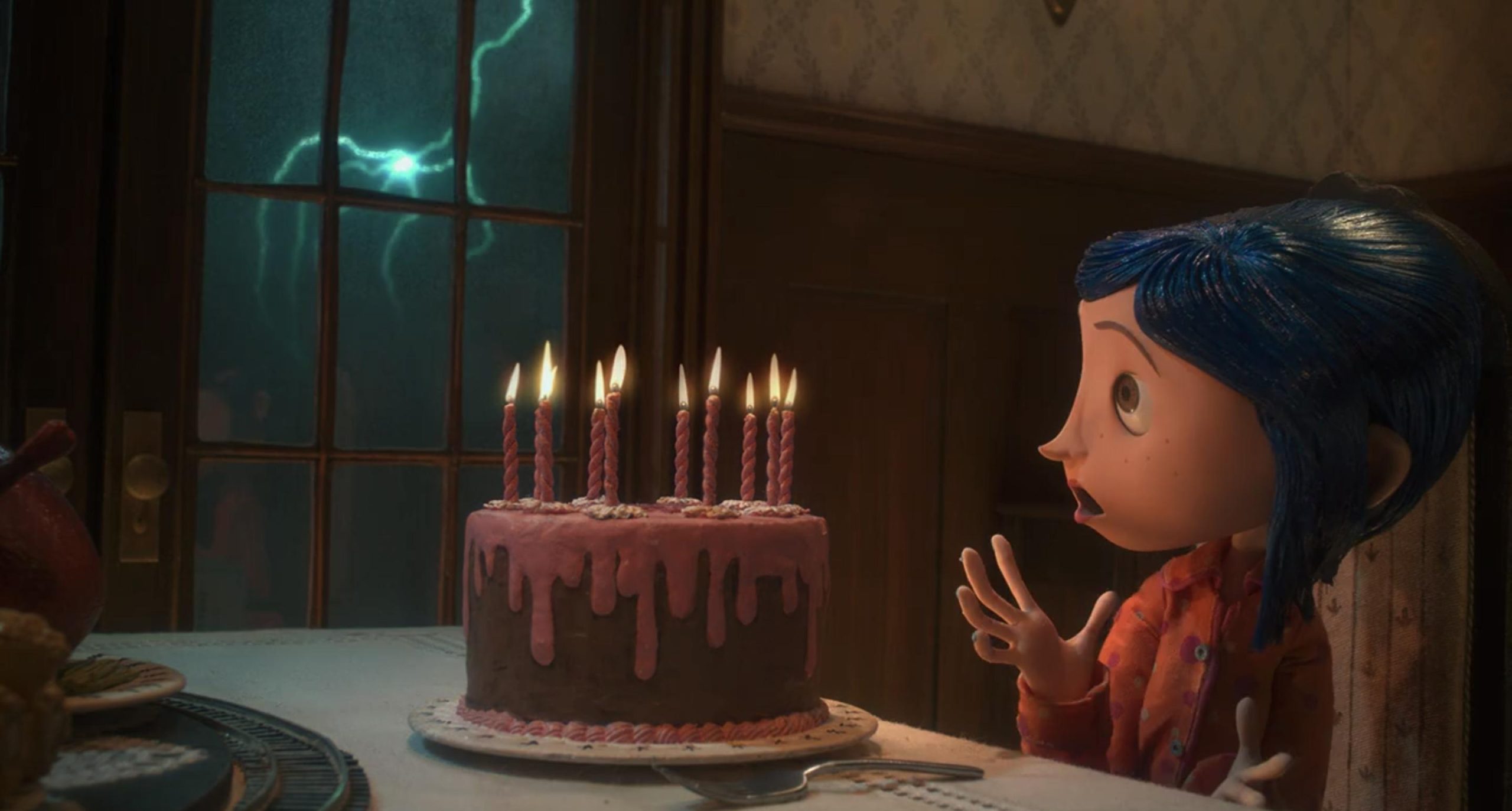 Coraline with her "Welcome Home" cake after returning to the other world.