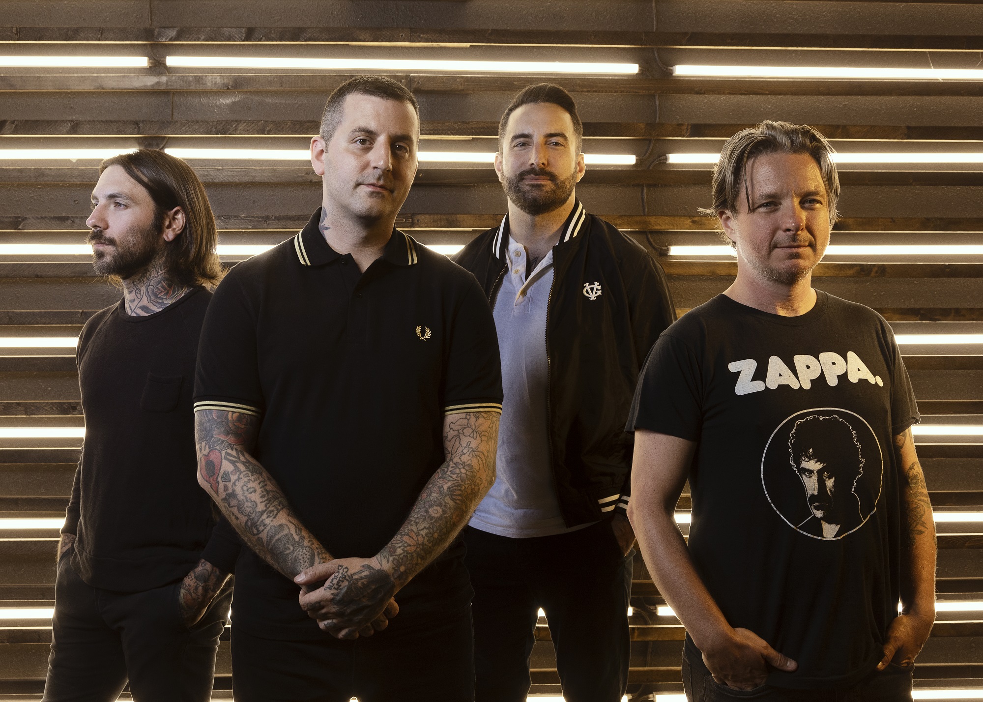 The members of Bayside pose in front of a garage door (“Vacancy.” Bayside. 2016. Hopeless Records.).