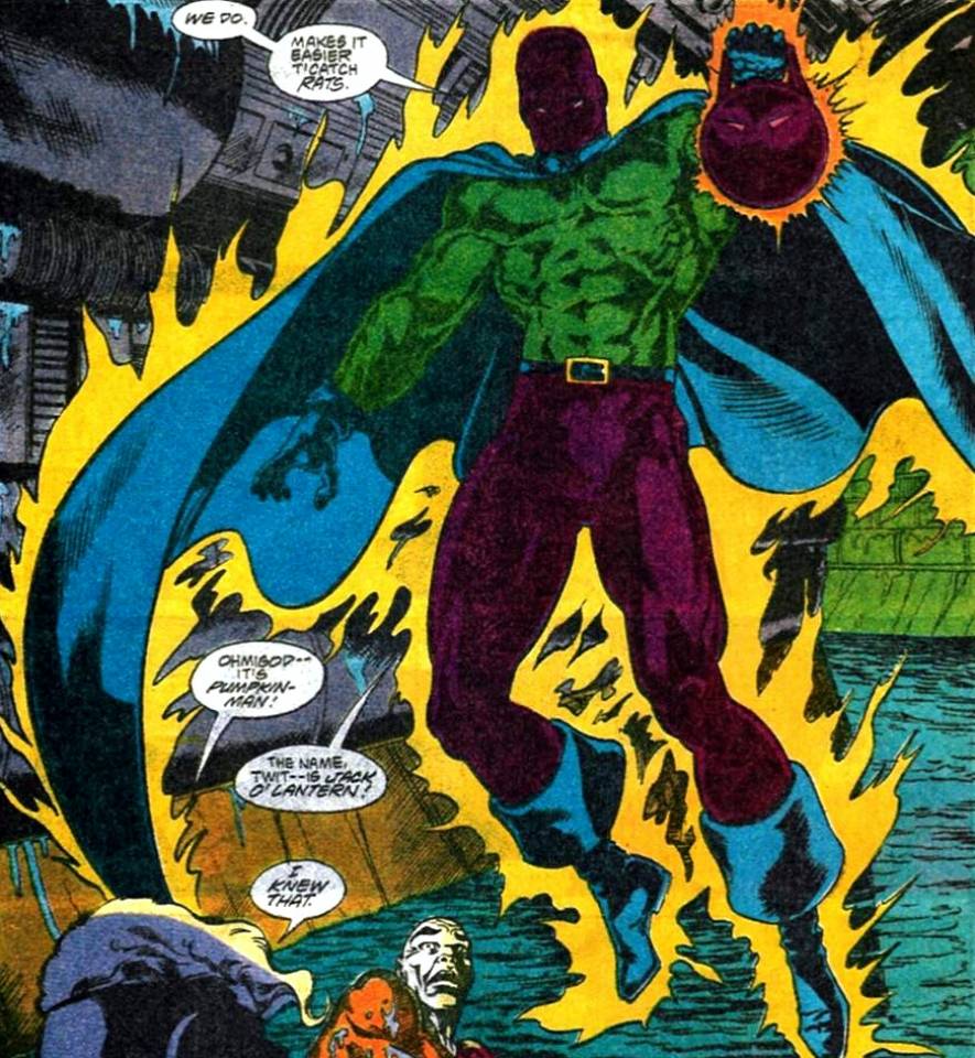 The Irish superhero Jack O'Lantern levitates, holding out his magical lantern. He emanates yellow energy while wearing a green shirt with a blue cape and a dark mask covering his entire face.