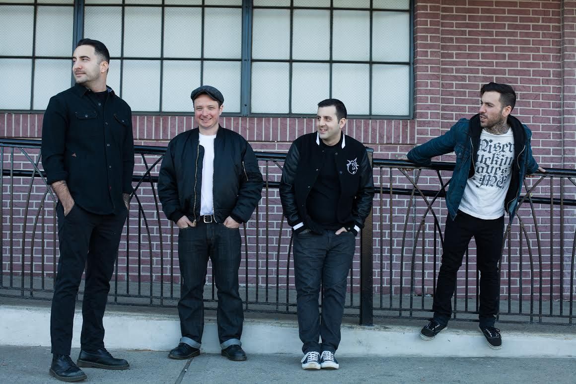 The members of Bayside pose in front of a brick wall (“Vacancy.” Bayside. 2016. Hopeless Records.).