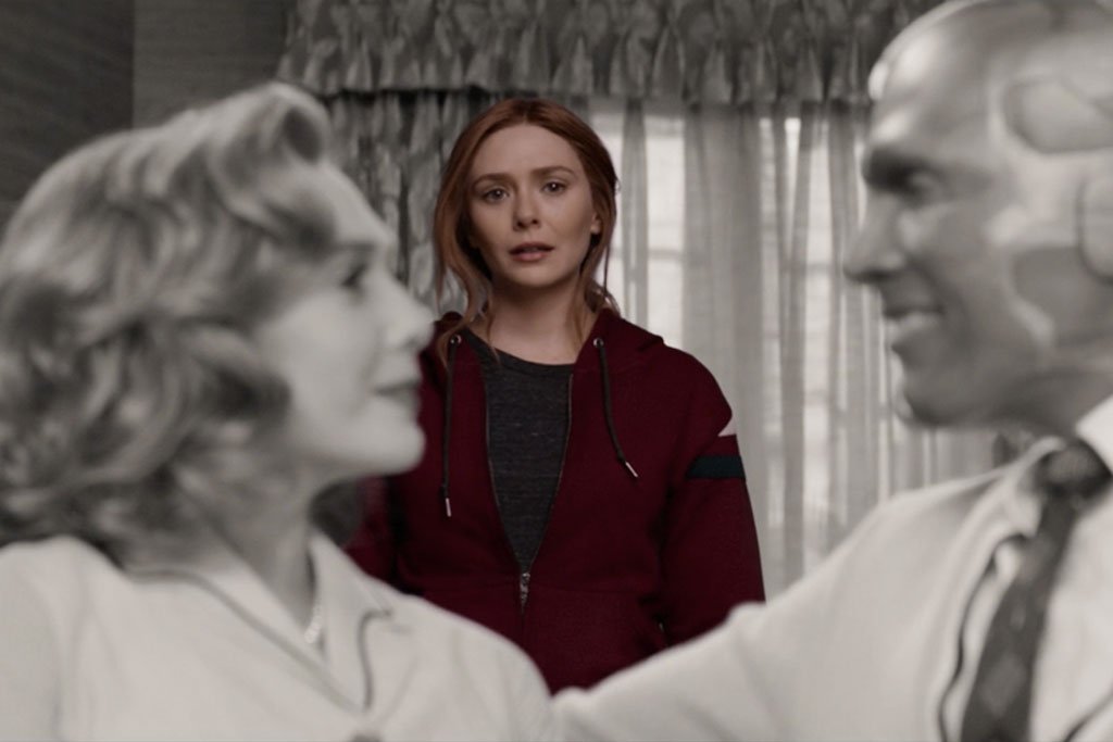 Wanda looks longingly on her and Vision's black and white sitcom selves (Shakman, Matt, dir. WandaVision. 2021. Marvel Studios.).