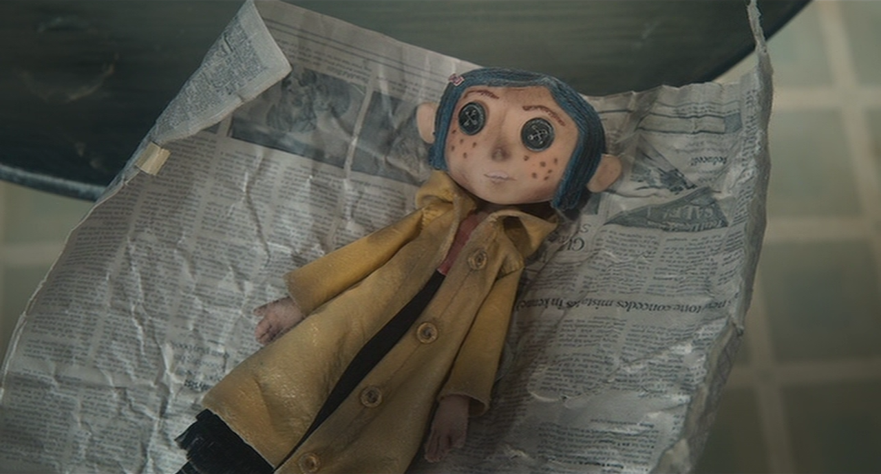 Coraline's doll in the newspaper Wybie gave it to her in.