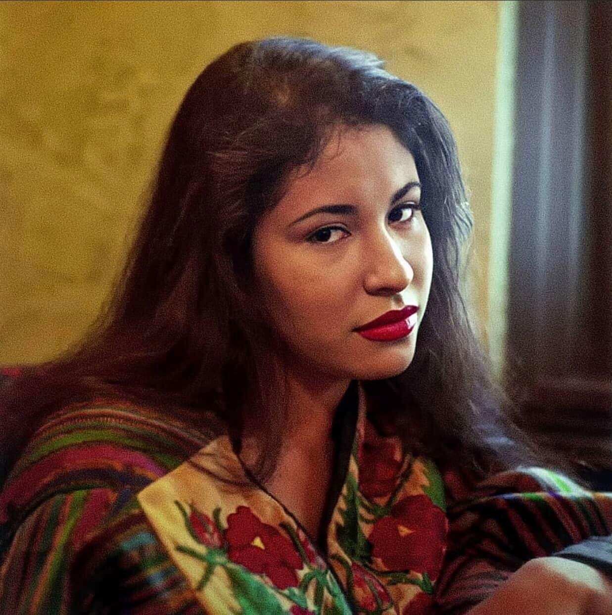 Selena, looking into the camera and wearing traditional Mexican clothing. 