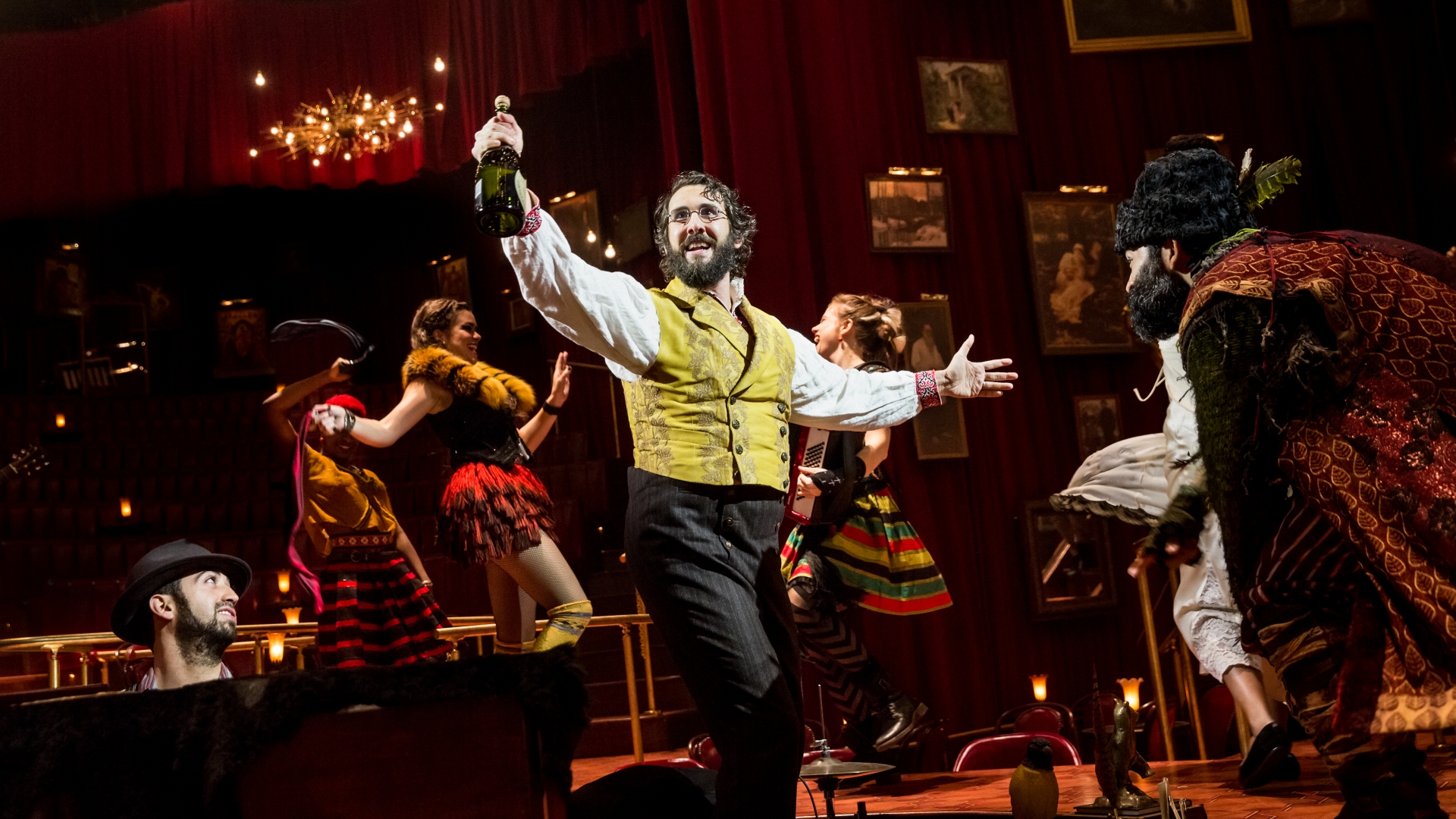 Pierre, played by Josh Groban, joyfully raises a bottle in a shot from Natasha, Pierre, and the Great Comet of 1812, 2016-2017 (Photo by Chad Batka).