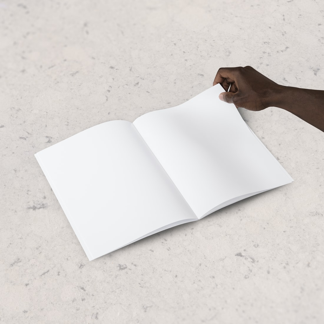 blank magazine with hand turning page. Source: anomaly. Unsplash.