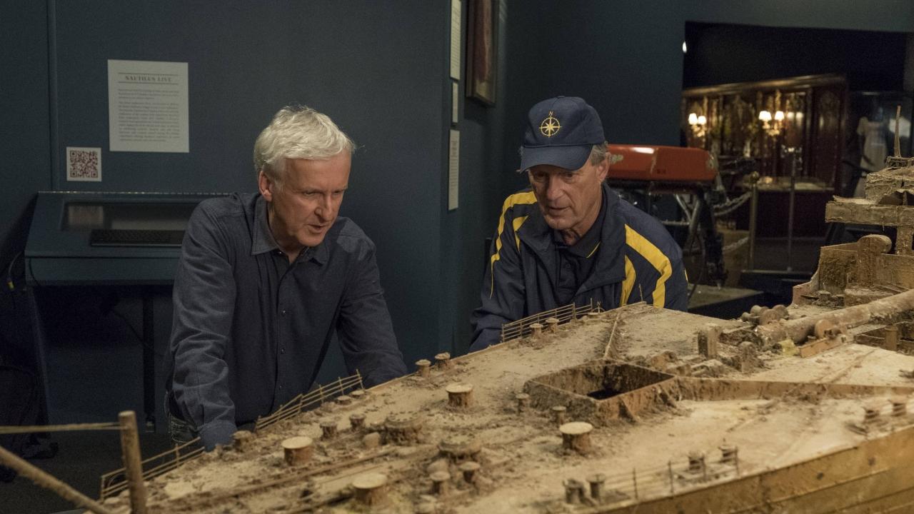 James Cameron and oceanographer, Bob Ballard, who first discovered Titanic's wreckage in 1985, examine a model of the sunken ship.