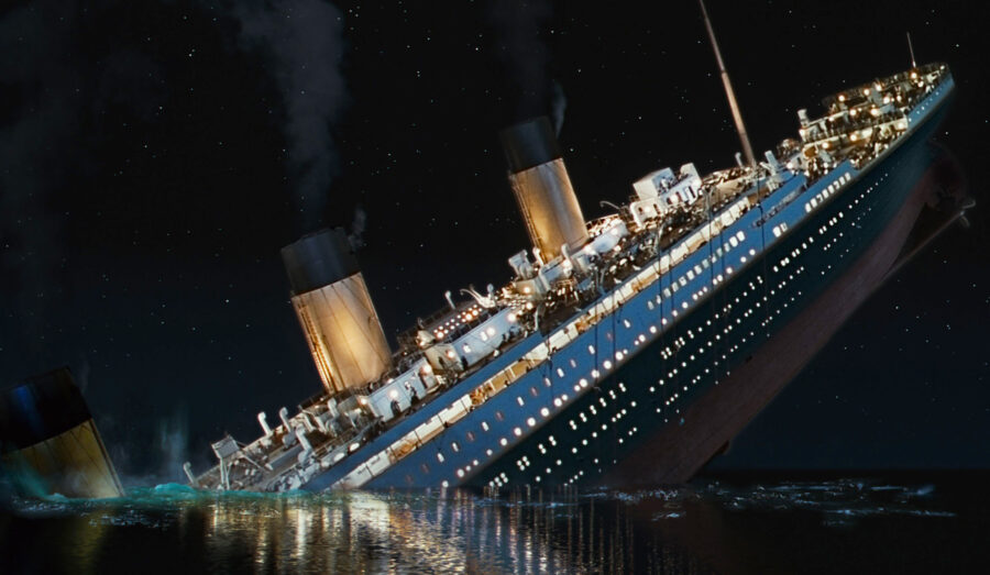 An image from the 1997 film, Titanic. The ship is sinking from the front and the back half is sticking out of the water.