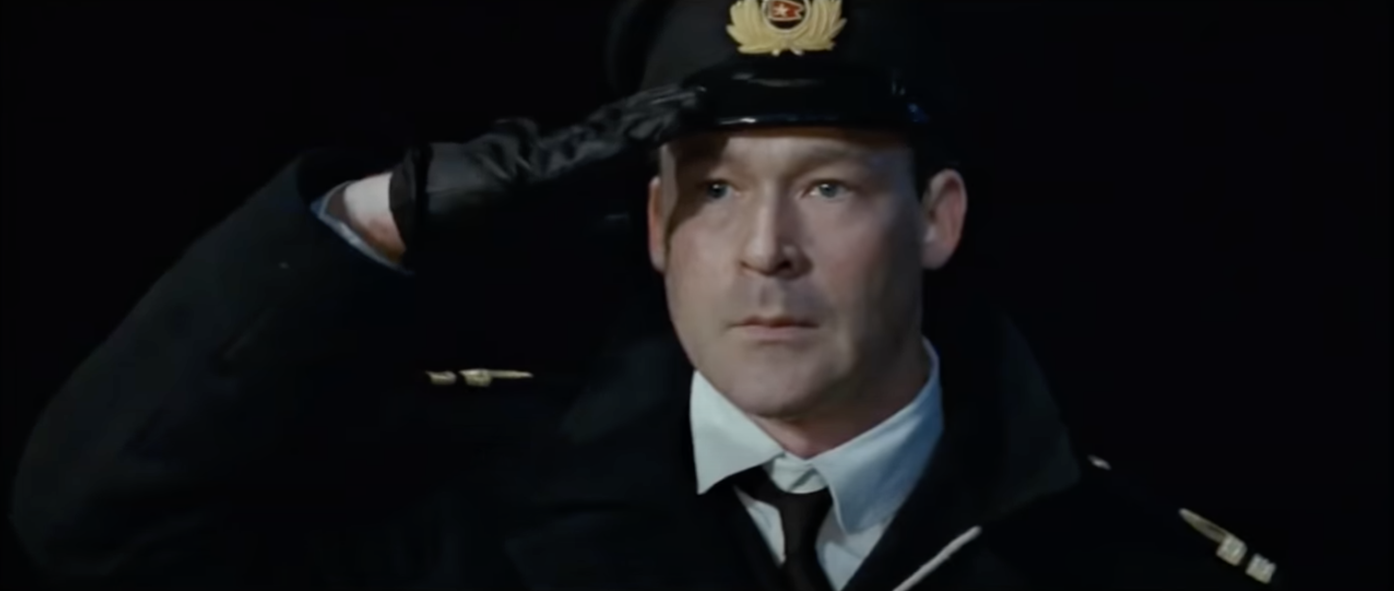 Officer Murdoch, portrayed by Ewan Stewart in the 1997 film, solutes a fellow officer who is off screen. 