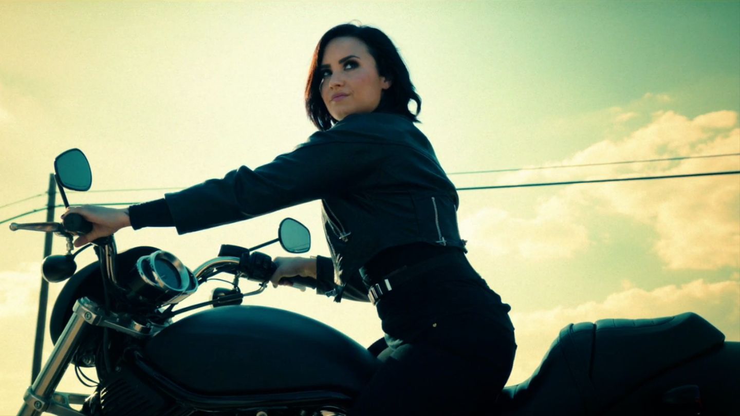 Demi Lovato rides off in a motorcycle in her music video for her song "Confident."