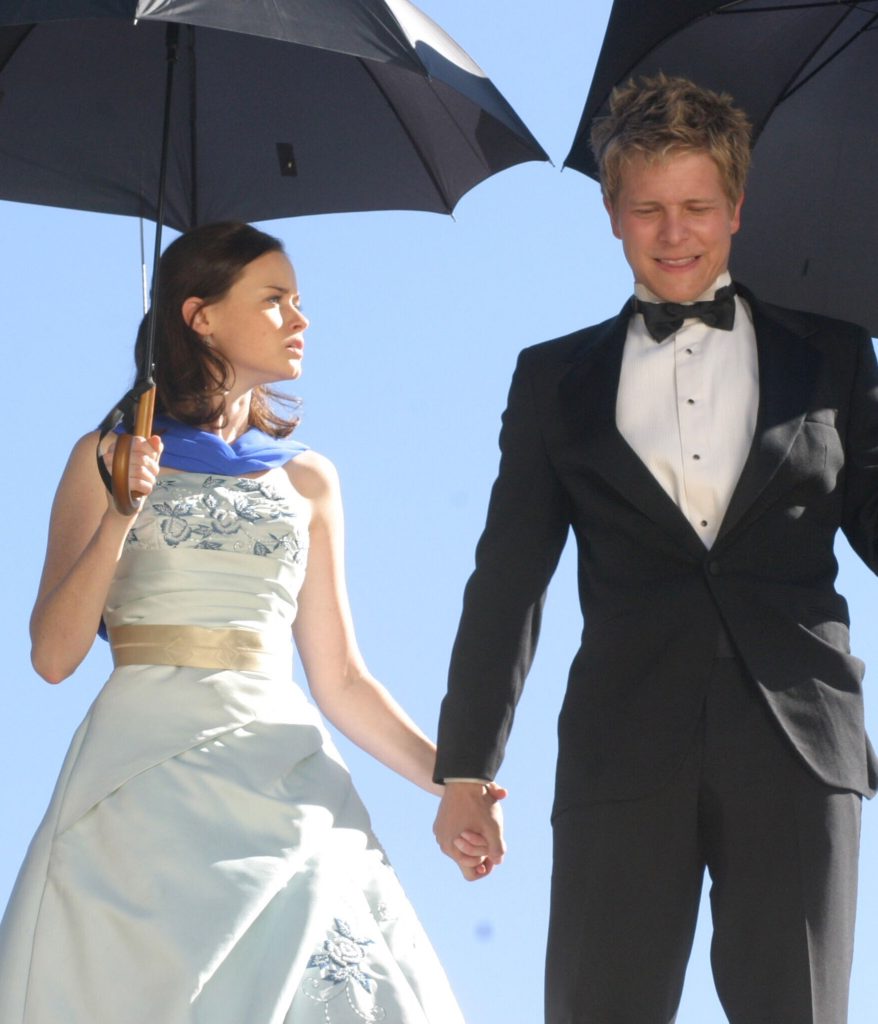 Rory and Logan prepare to jump from a tall structure while glamping in a shot from Gilmore Girls, 2000-2007 (The WB).