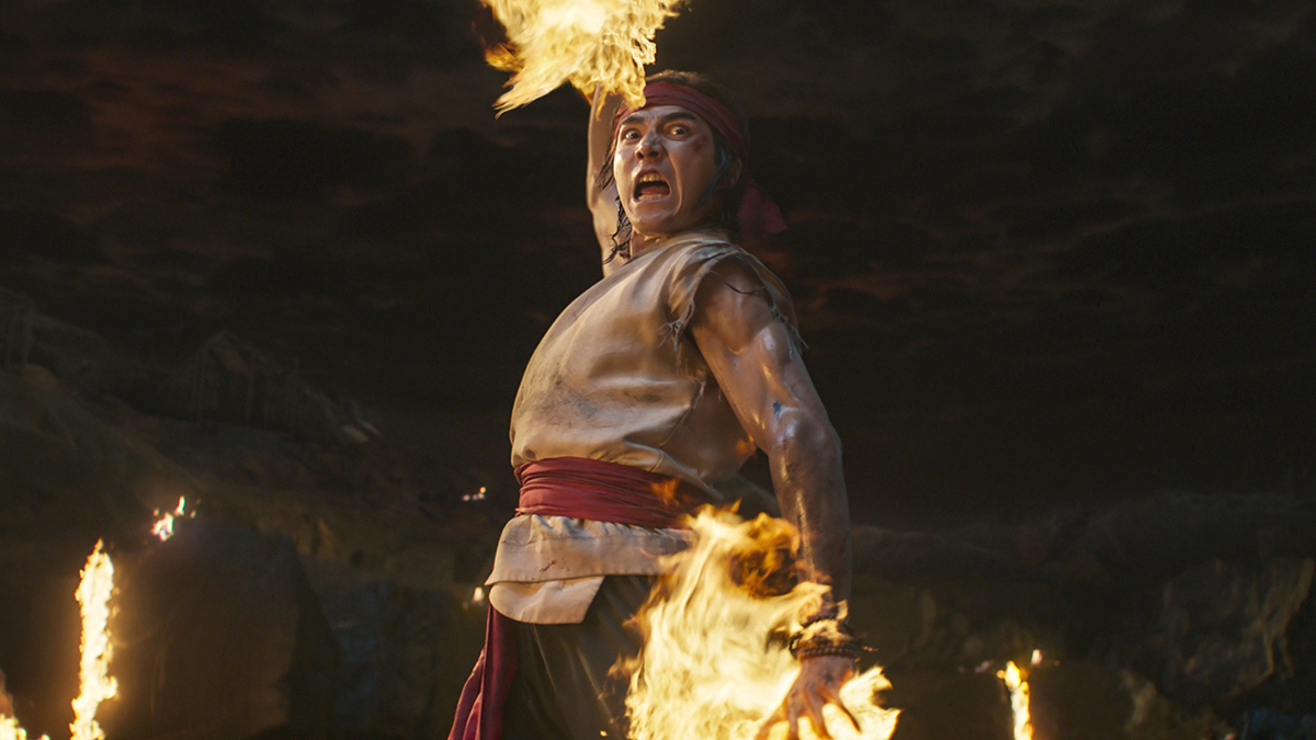 Ludi Lin as Liu Kang using his fireball arcana in battle in Mortal Kombat (2021),