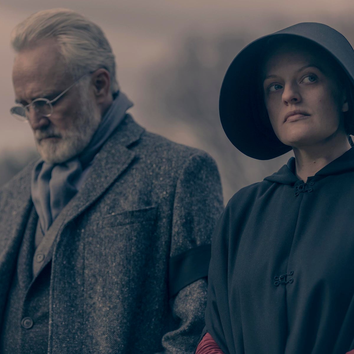 June and Commander Lawrence dressed in black for a funeral. 