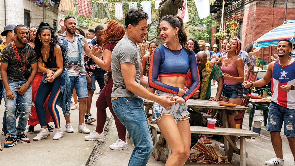 Anthony Ramos as Usnavi and Melissa Barrera as Vanessa Morales with the ensemble of In the Heights in the film In the Heights (2021).