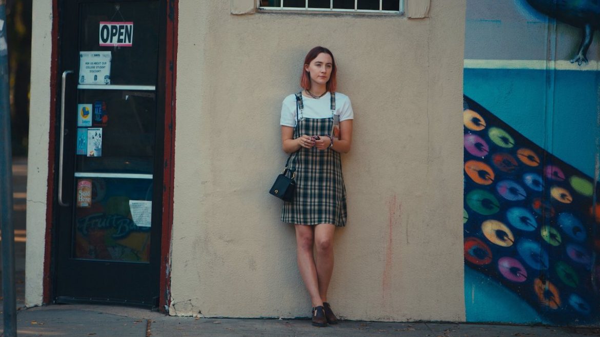 Lady Bird stands outside a shop on her eighteenth birthday