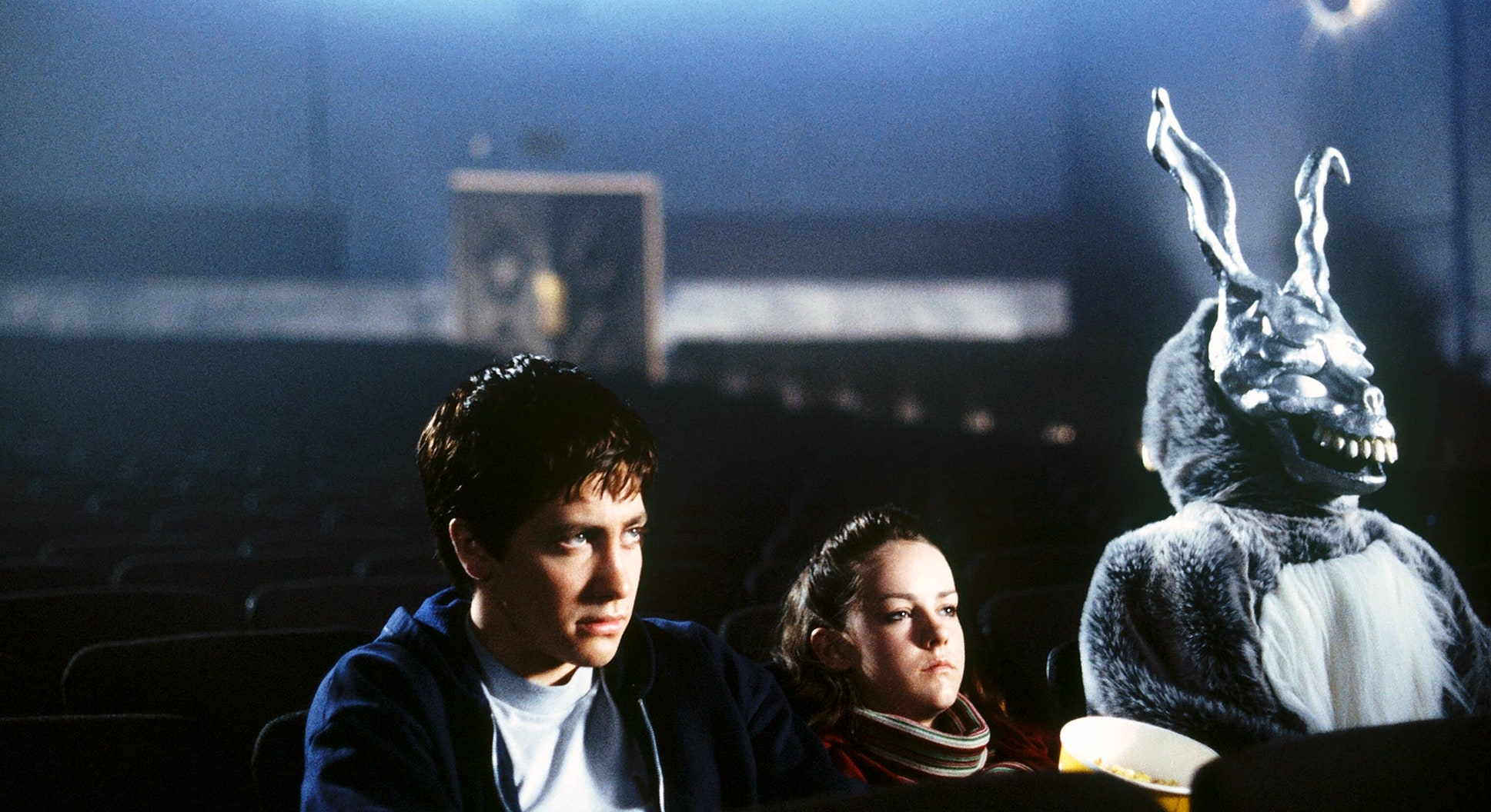 Donnie Darko sits in a movie theater with Gretchen and Frank.