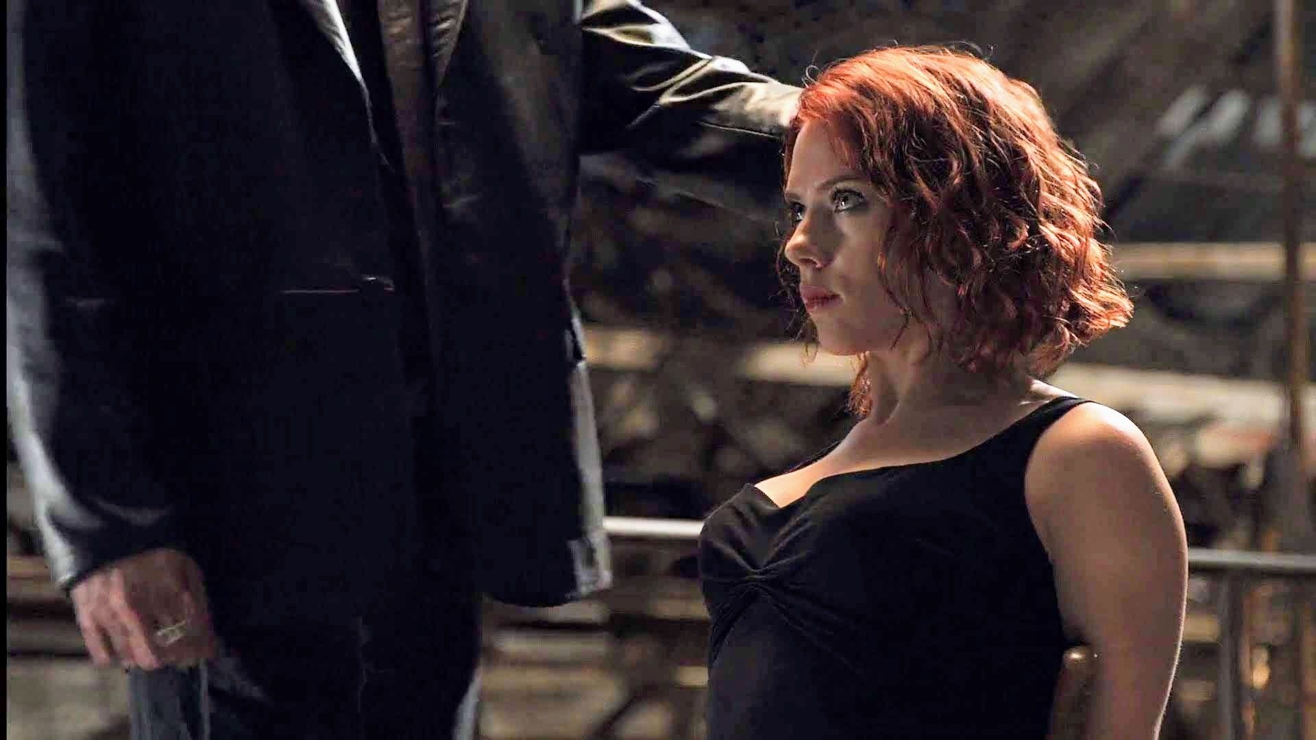 Scarlett Johansson as Natasha Romanoff tied to a chair and being interrogated in Avengers (2012).