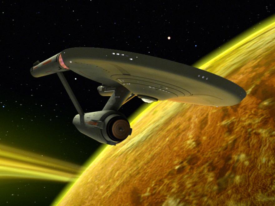 The Starship Enterprise flies past a bright yellow planet. (Roddenberry, Gene, Creator. Star Trek: The Original Series. 1966-1969.)