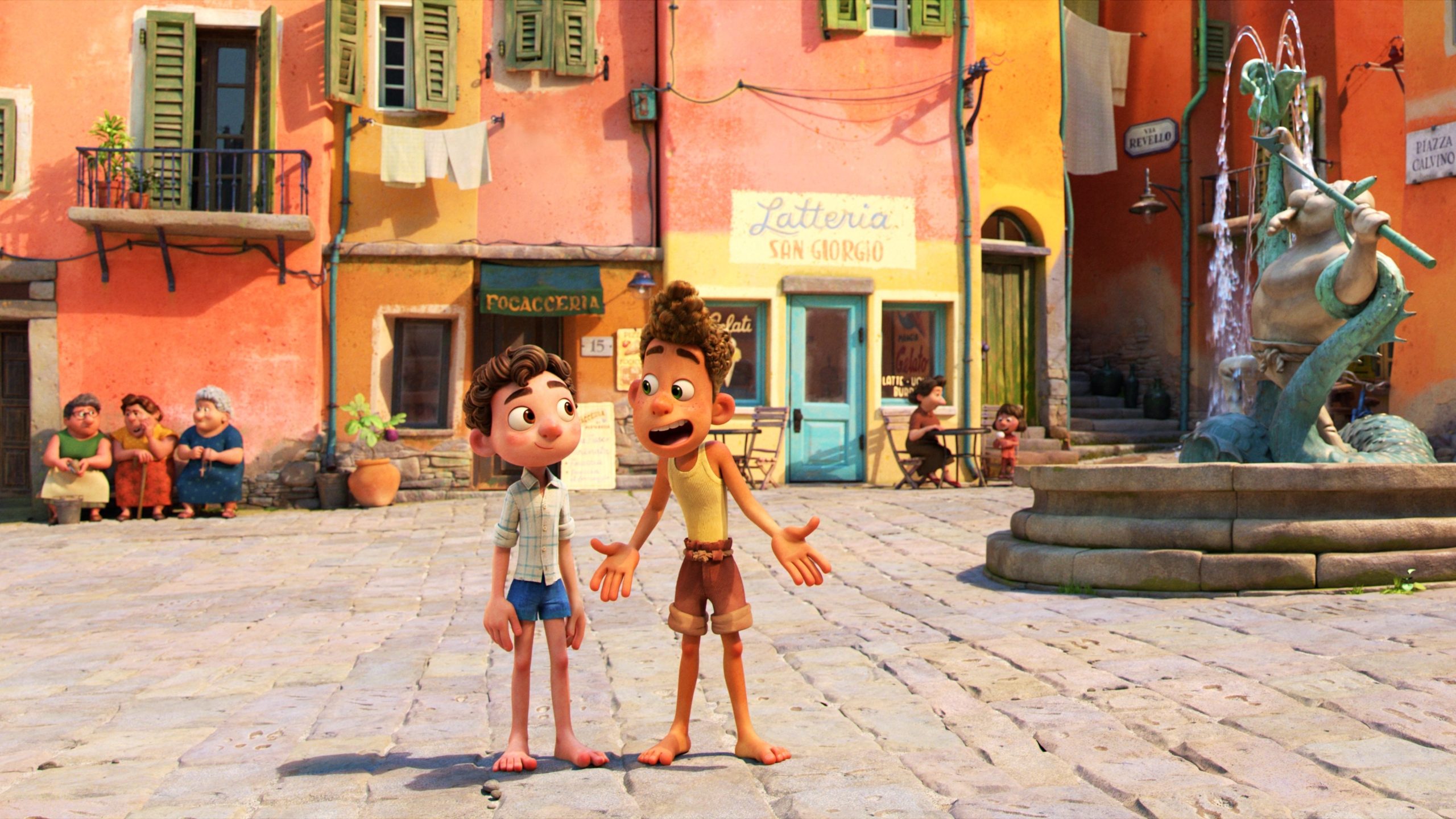 Luca and Alberto talk in the town square.