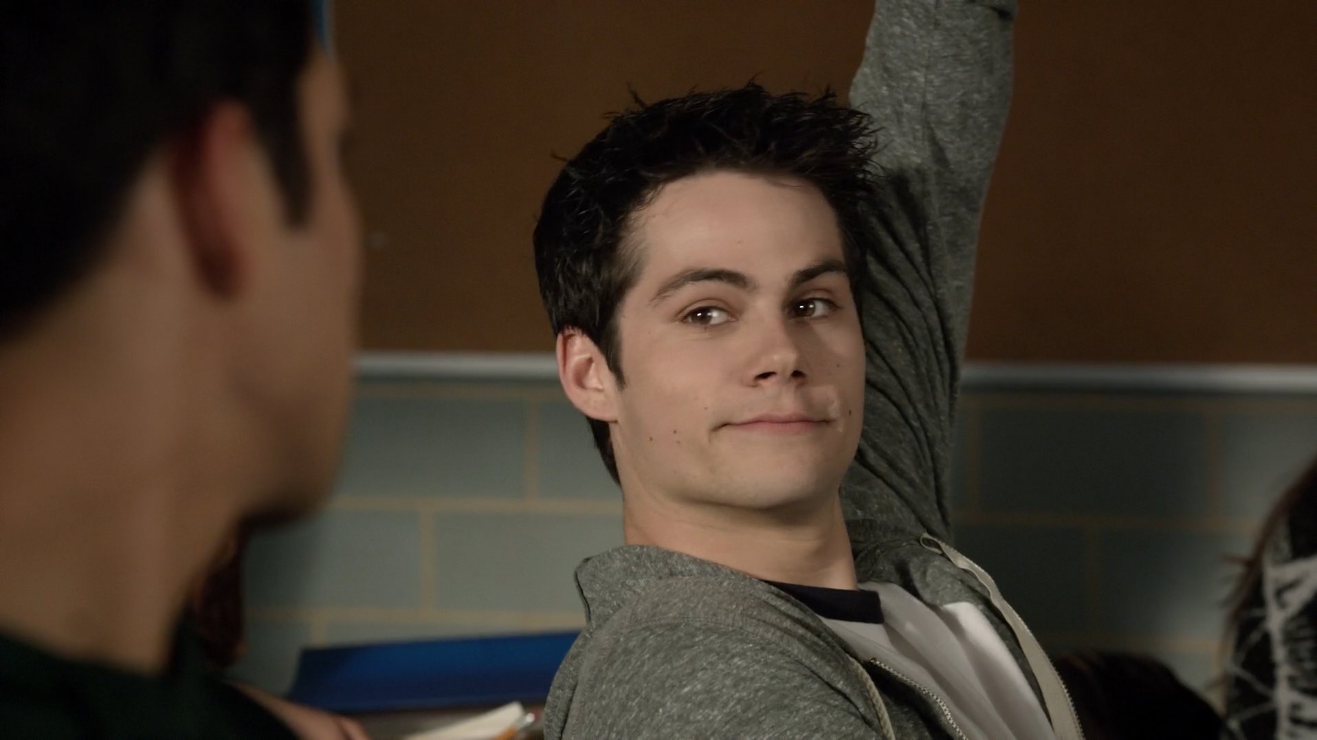 Stiles Stilinski smiling at his best friend, Scott, while raising his hand ...