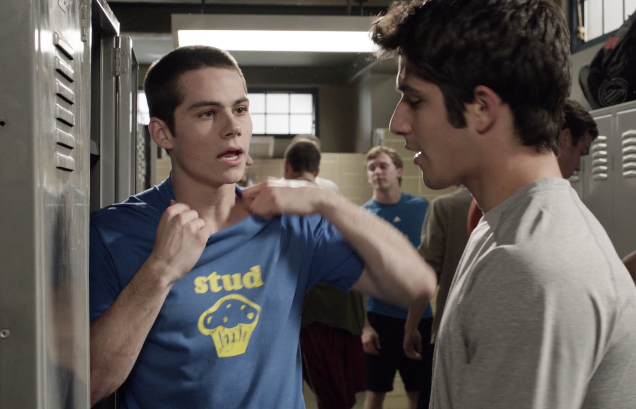 Stiles Stilinski and Scott McCall laughing with one another in their high school hallway in Teen Wolf (2011-2017)