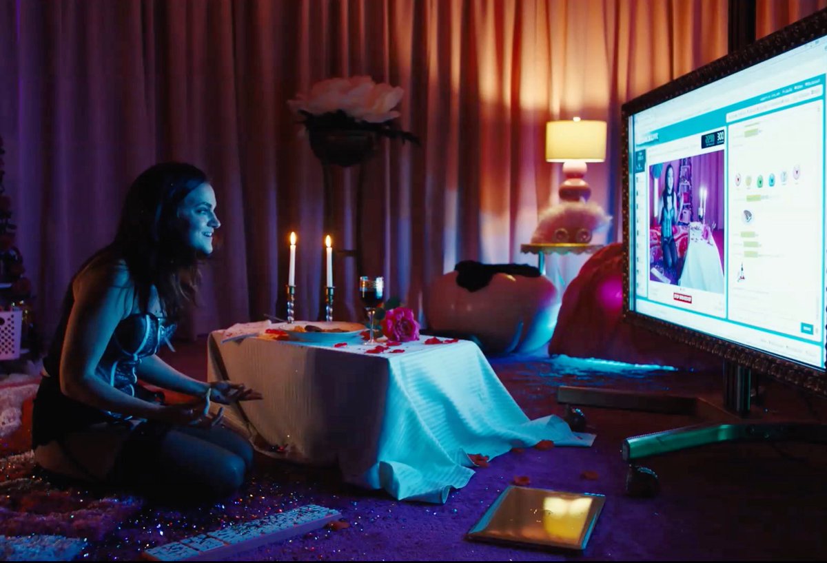 Alice (Madeline Brewer) is sitting in front on the floor in front of a computer screen as she is on the job as a sex worker.