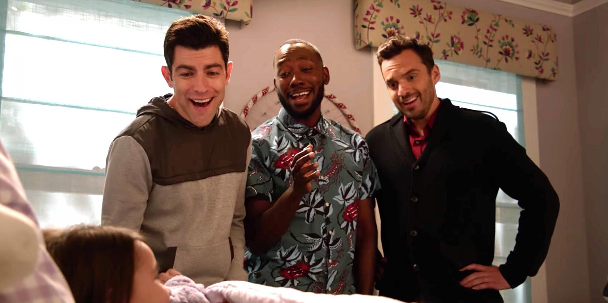 Winston Schmidt, Winston Bishop, and Nick Miller having a laugh while putting Schmidt's daughter, Ruth, to sleep in New Girl (2011-2018).
