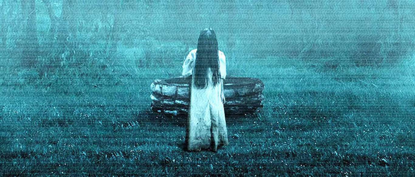 Daveigh Chase plays Samara Morgan in this classic horror film The Ring as she is standing in front of well with her hair covering her face.