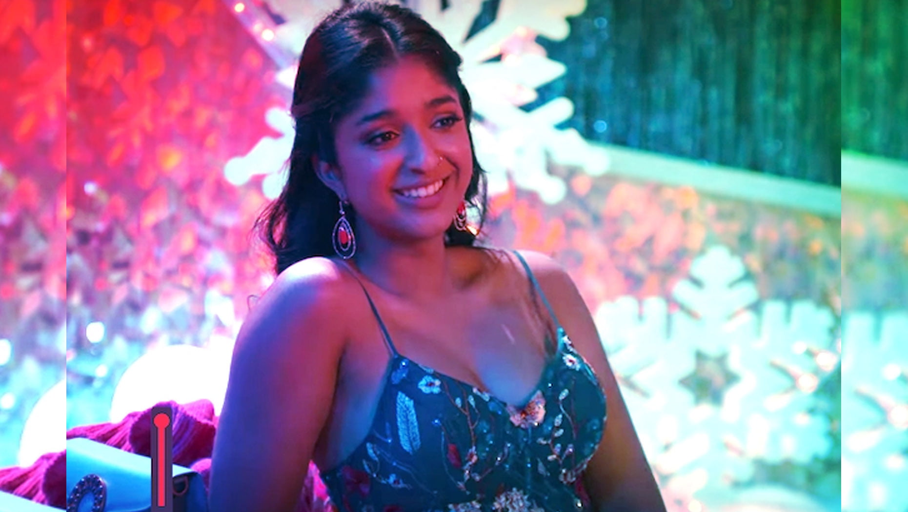 Never Have I Ever's Devi, at the school dance in the season two finale, smiles at friends off-screen.