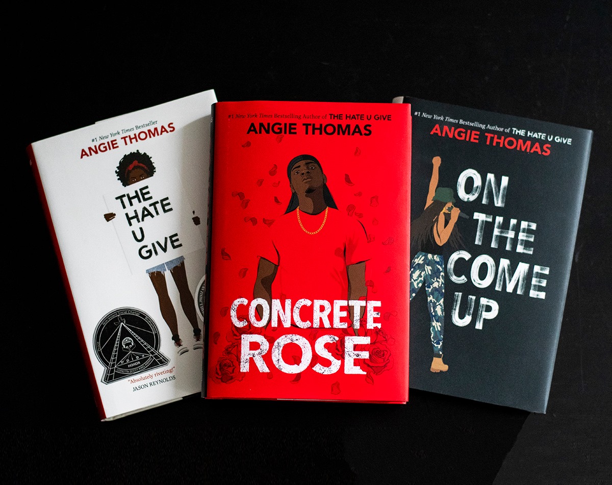 A photo shows three books written by Angie Thomas in celebration of Book Lover's Day. "@HarperCollinsCanada." Angie Thomas Books. 2021.