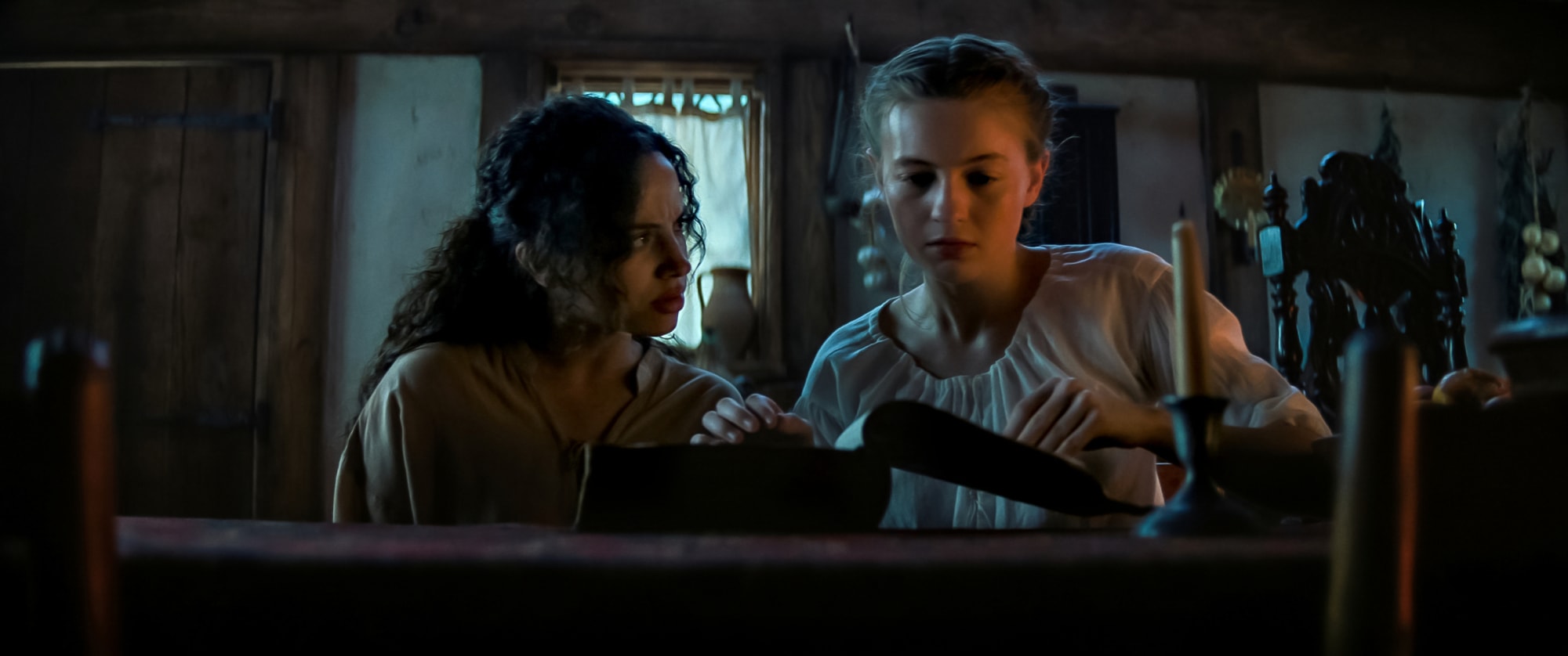 From Left to Right: Kiana Madeira and Olivia Scot Welch as Sarah Fier and Hannah Miller in, "Fear Street Part Three: 1666."
