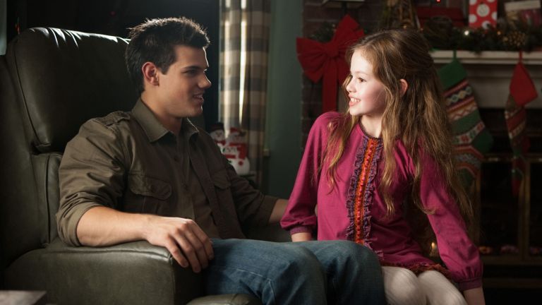 Taylor Lautner as Jacob Black and Mackenzie Foy as Renesmee Cullen in 'Breaking Dawn -- Part 2' (2012).