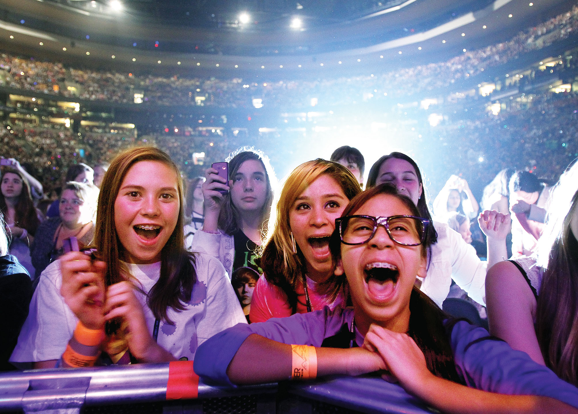 Teen girls screaming at a concert.