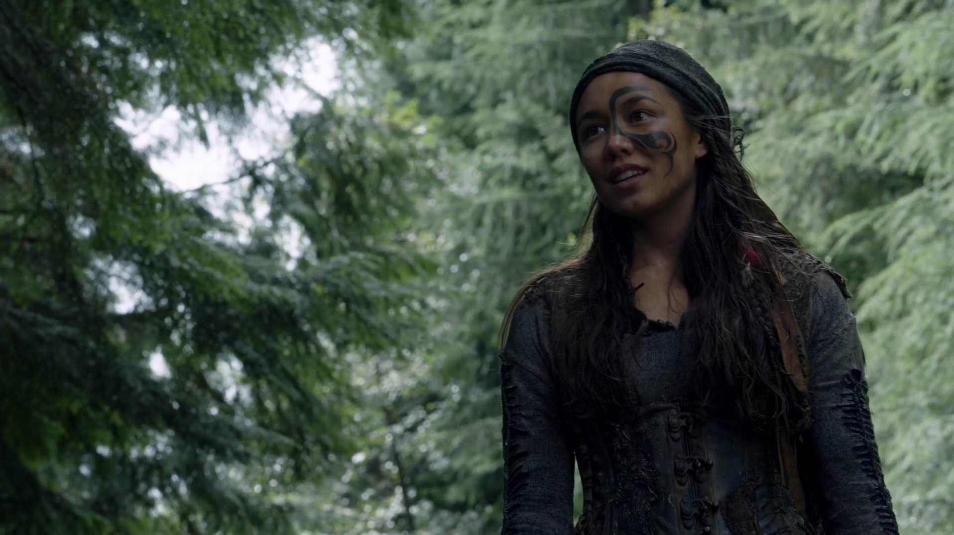 Emori from "The 100" poses outside, while working with members of the 100. 