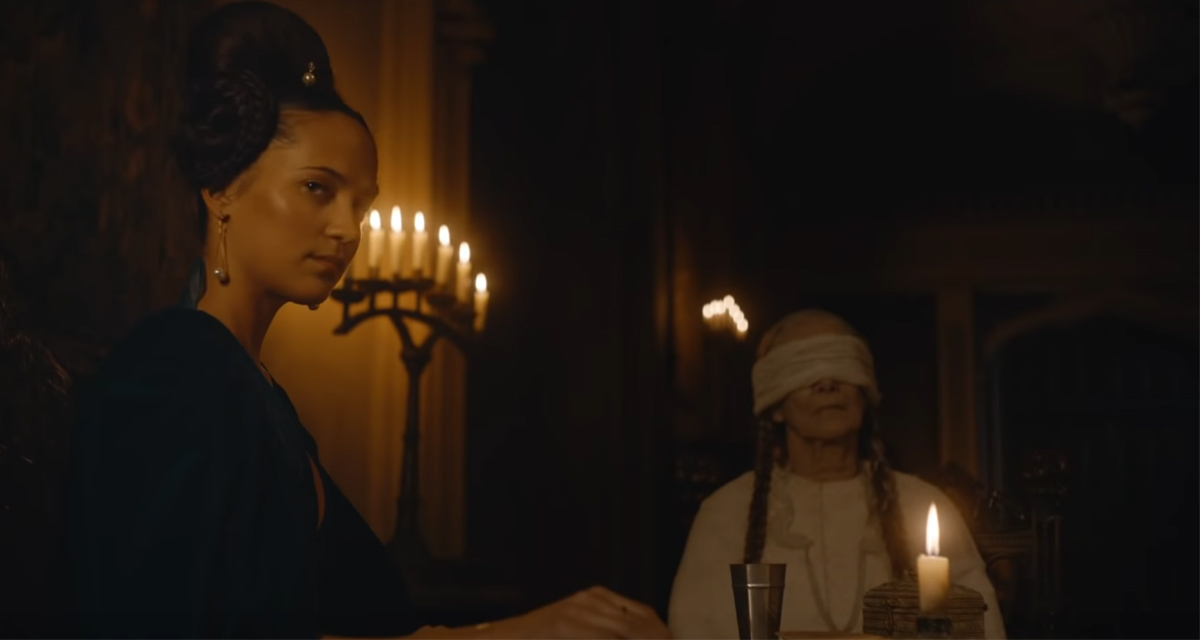 Alicia Vikander as the Lady and Helena Browne as the Blinded Woman in The Green Knight (2021).