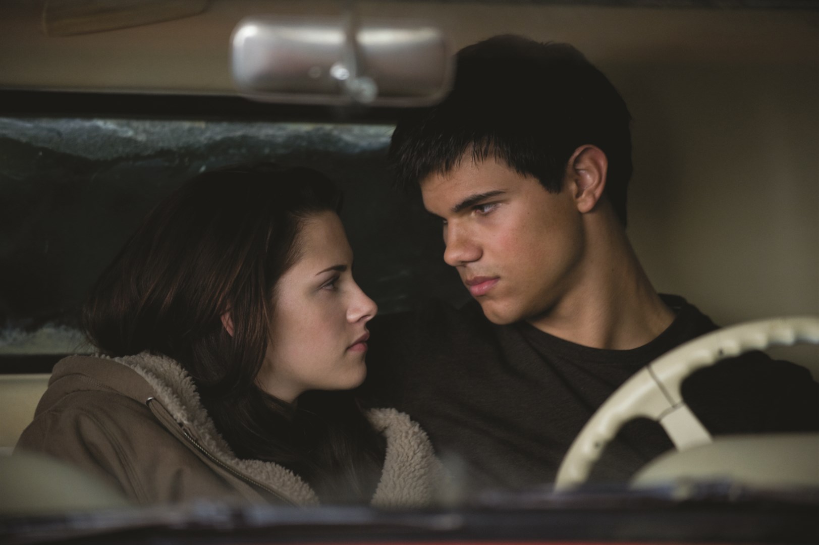 Bella Swan and Jacob Black sitting inside Bella's truck in 'New Moon' (2009).