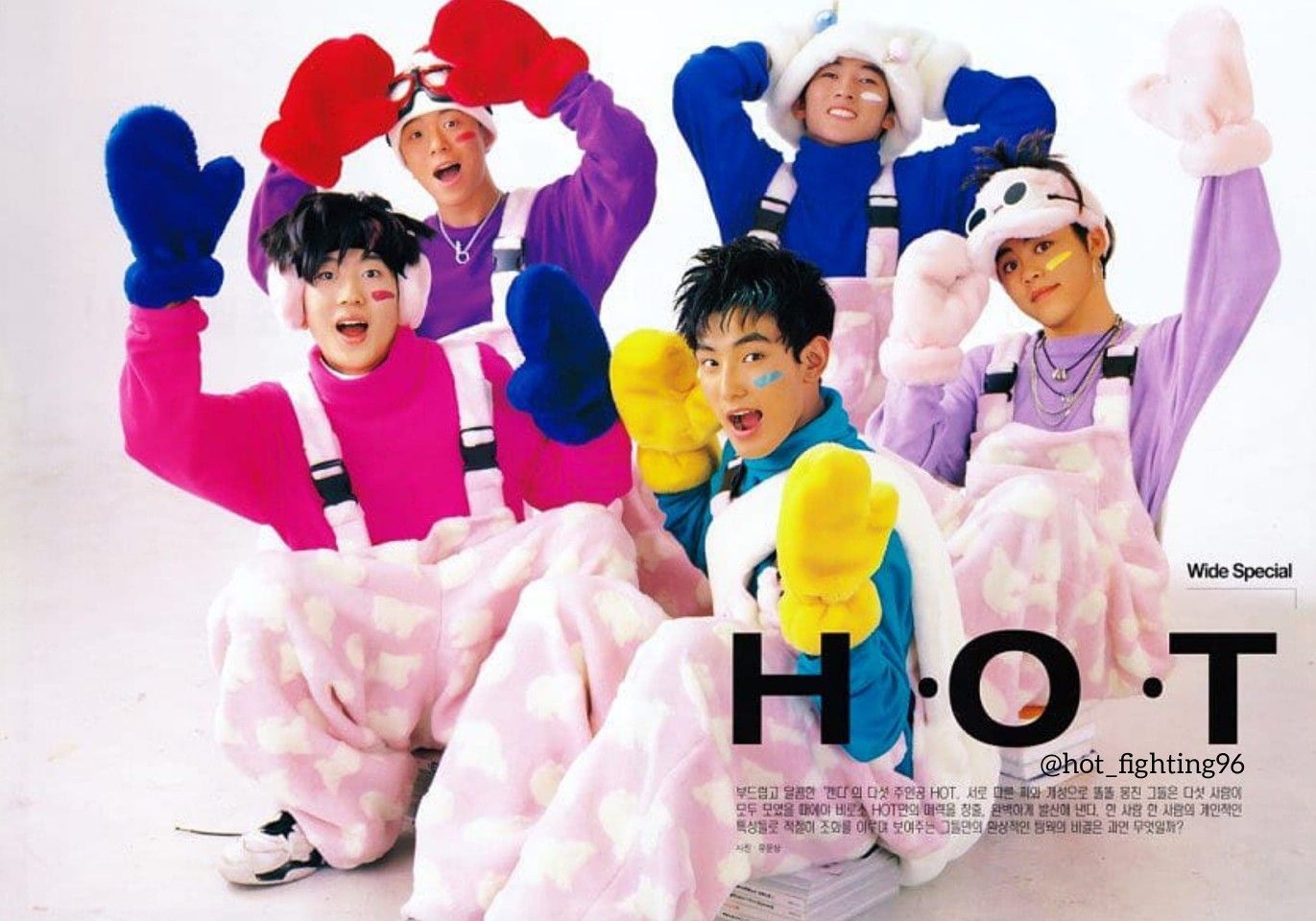 Five young men, in fuzzy overalls and colorful mittens, pose with smiles for a photoshoot.