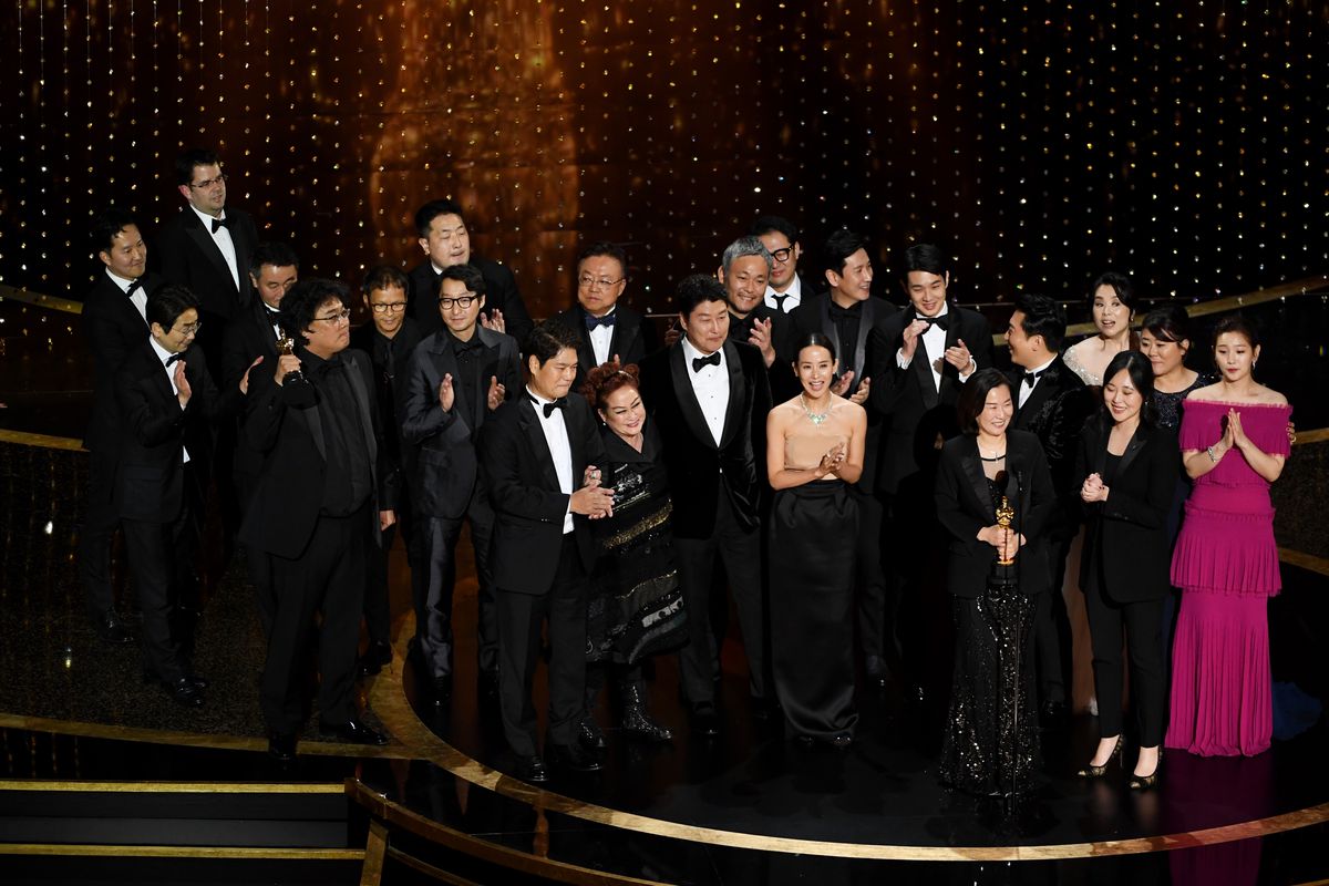 The cast and crew of Parasite, on stage after winning Best Picture at the Oscars.