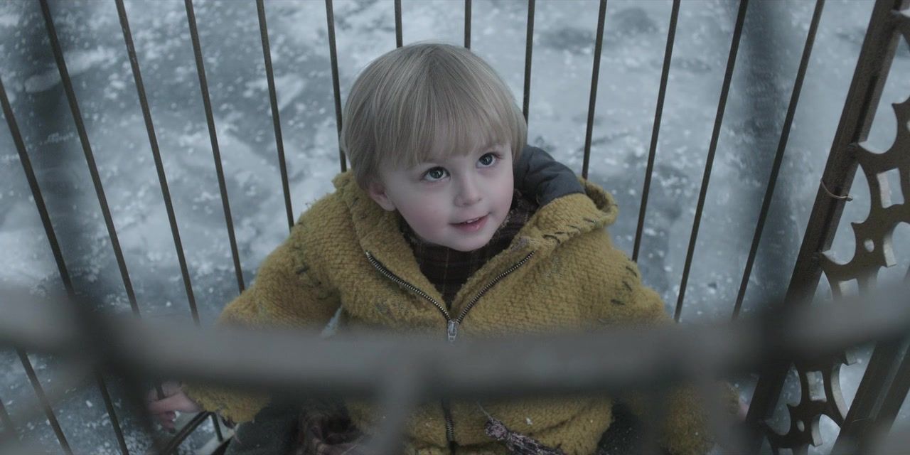 Sunny sits in a cage wearing a yellow jacket. A Series of Unfortunate Events. Season 3, Episode 1: "The Slippery Slope: Part One." 2017-2019. Netflix Entertainment.