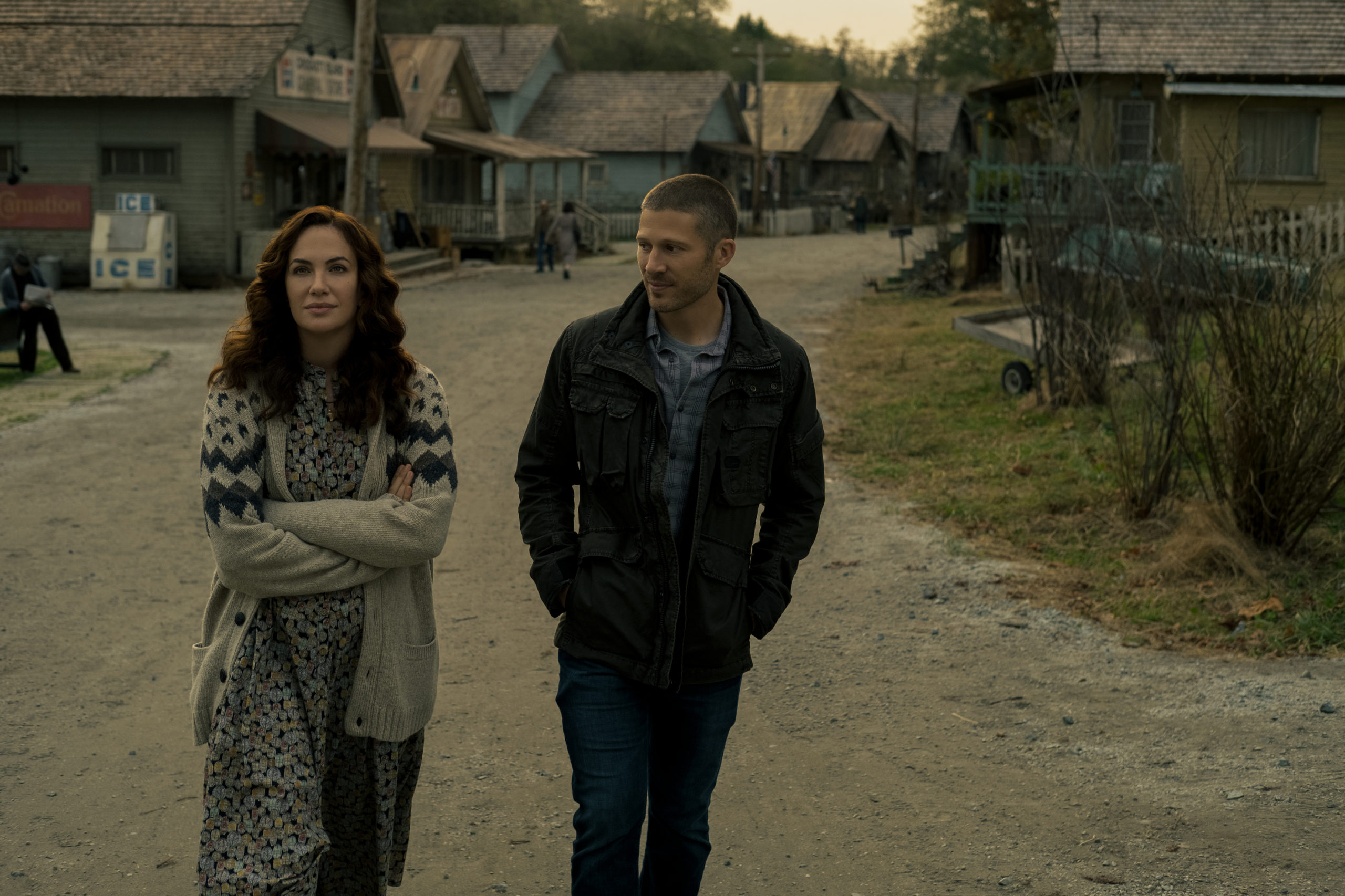 Characters Erin Greene and Riley Flynn walk through Crocket Island. Midnight Mass. Season 1, Episode 1: "Book I: Genesis". 2021. Netflix Entertainment. 