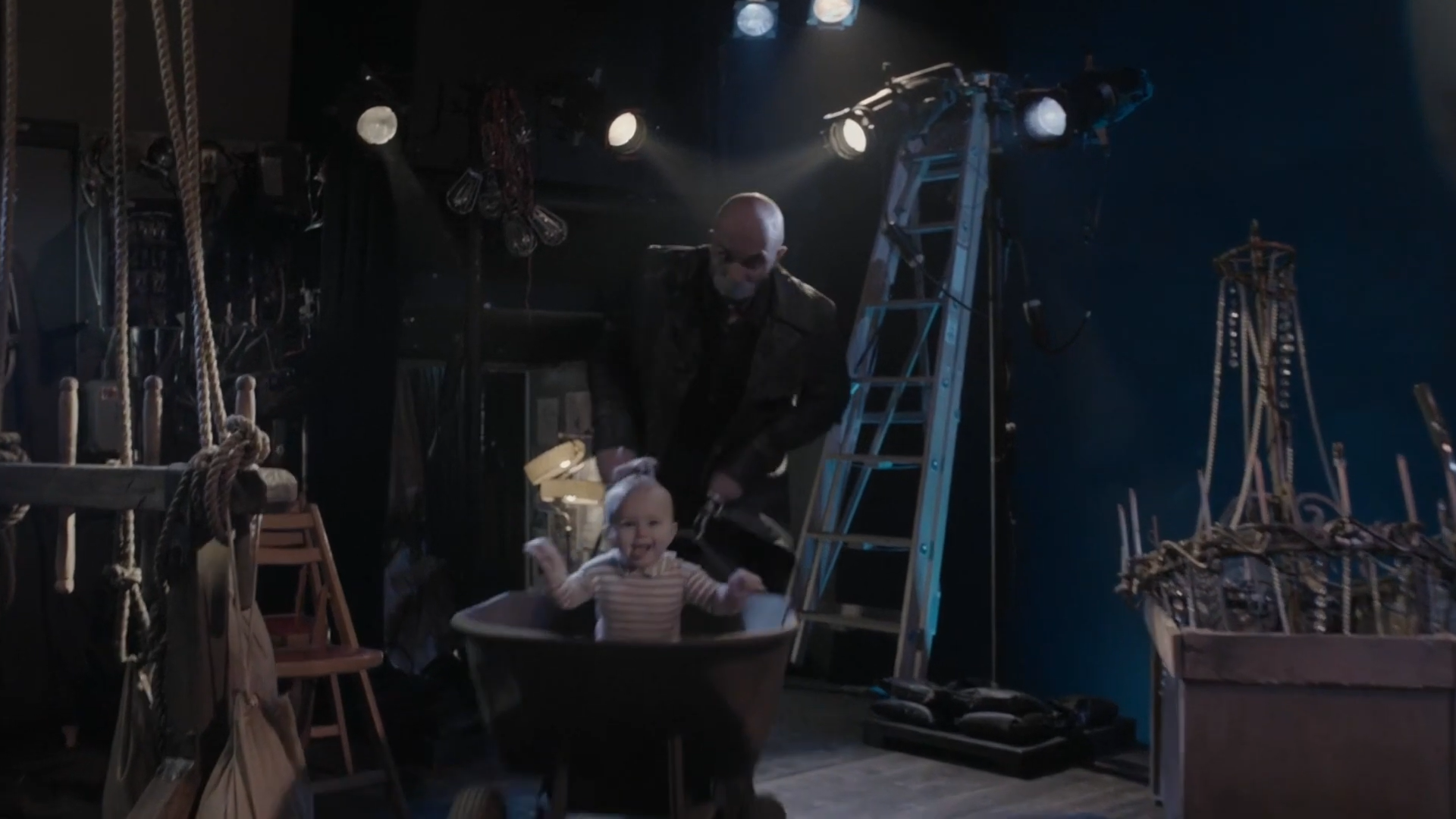 The Hook-Handed Man pushes Sunny in a wheelbarrow. A Series of Unfortunate Events. Season 1, Episode 2: "The Bad Beginning: Part Two." 2017-2019. Netflix Entertainment. 