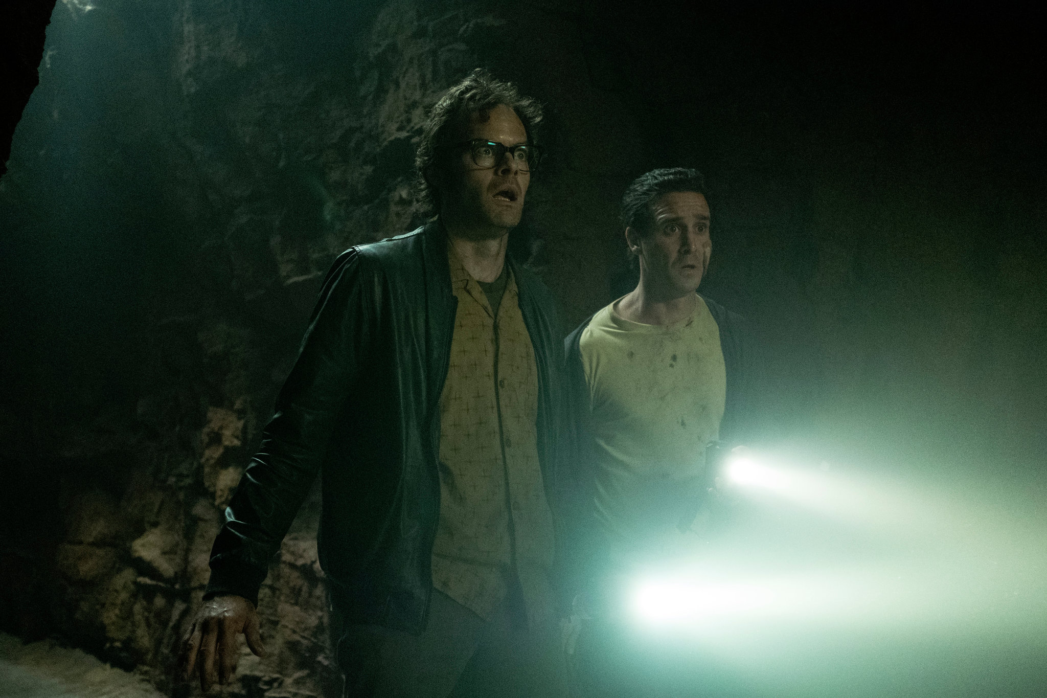 Queer representation in 2019: Richie (Bill Hader) and Eddie (James Ransone) are standing in shock with their flashlights shining. 