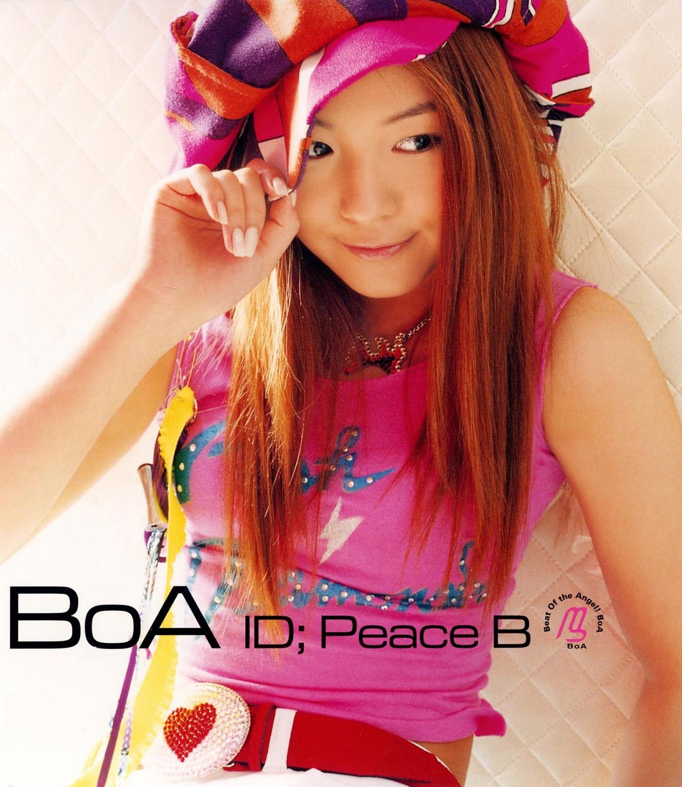 BoA, a fourteen-year girl old, poses wearing a hot pink hat and shirt for her first album.