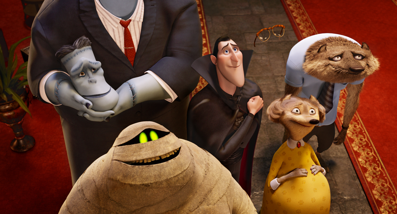 The characters of Hotel Transylvania (2012), Dracula, Frankenstein's Monster, The Wolf Man (with his wife), The Invisible Man, and The Mummy all smile and stand in a group together. 