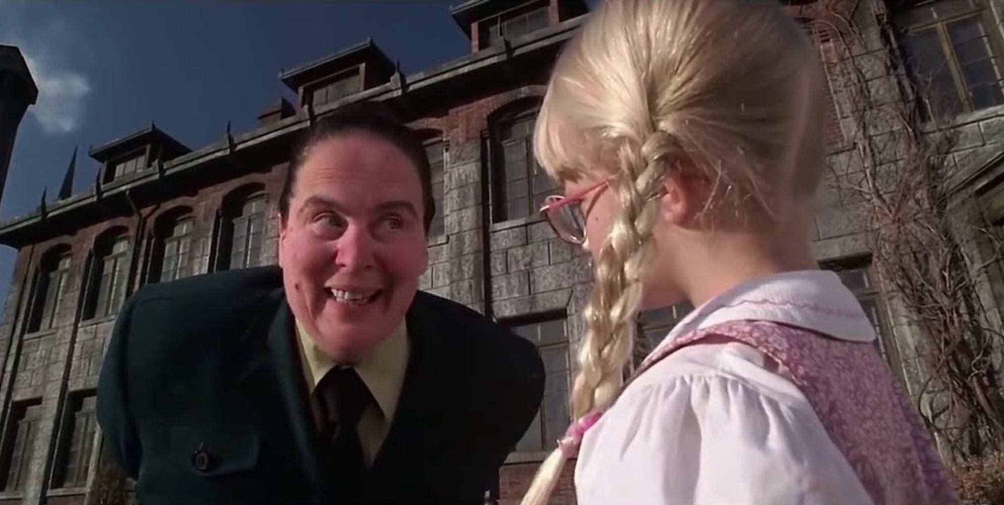 A still from the Matilda film of a terrifying Miss Trunchbull as she intimidates poor, pigtail-loving Amanda.