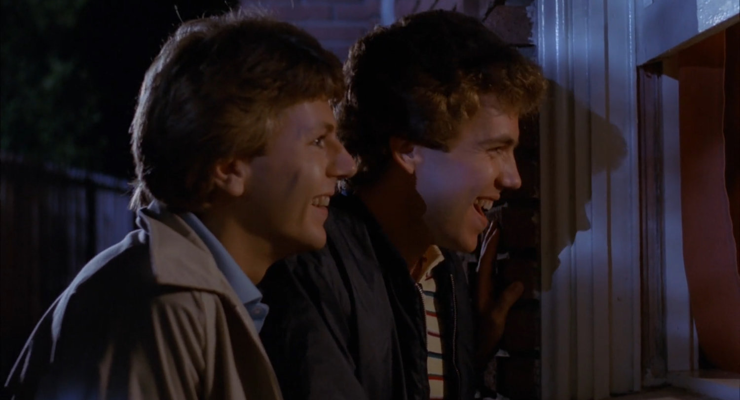 Male characters in Amy Holden Jone's 'The Slumber Party Massacre' (1982) shown peering into windows to spy on a girl's sleepover.