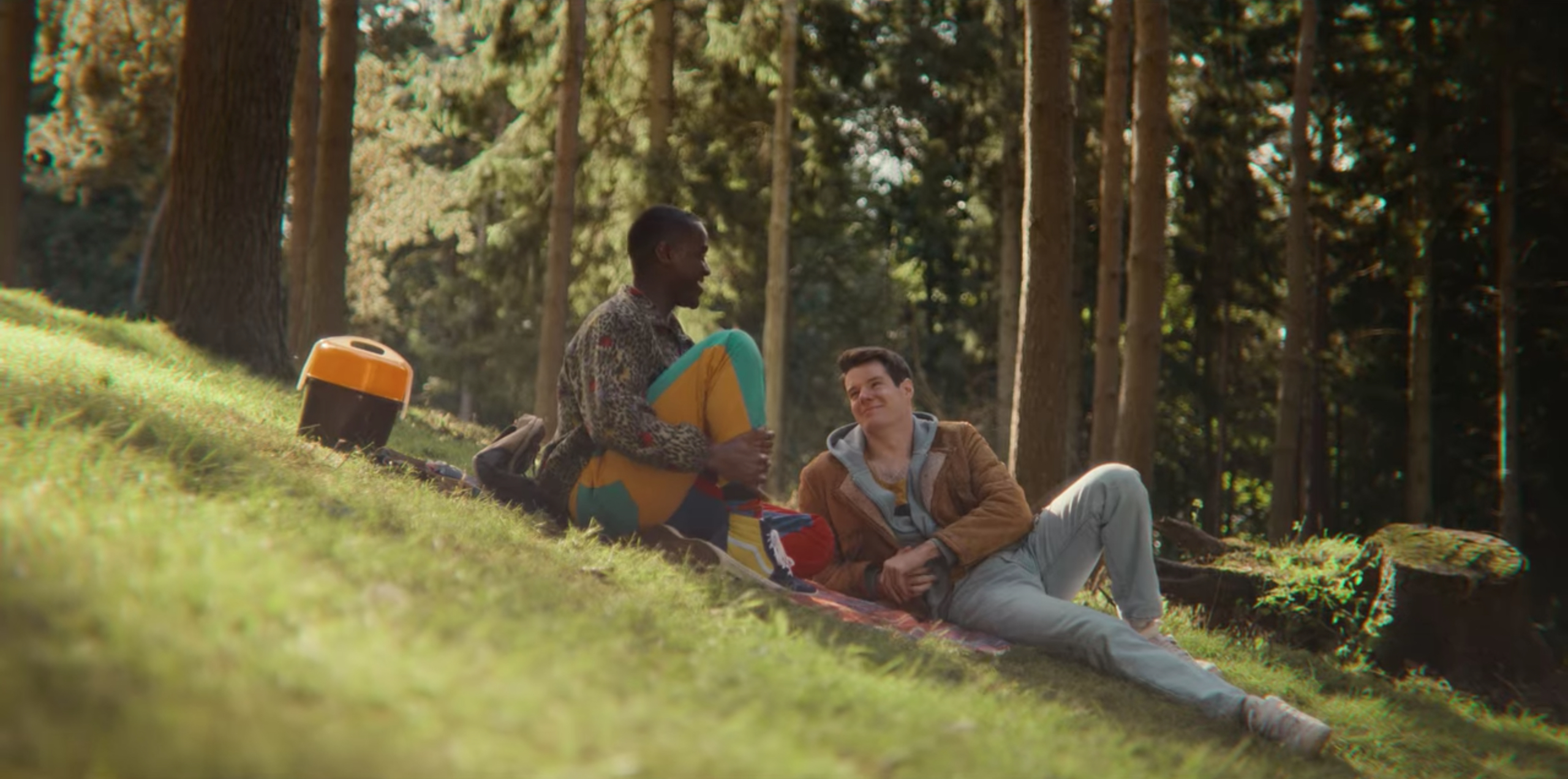 Eric and Adam look lovingly at each other while on a picnic date. 