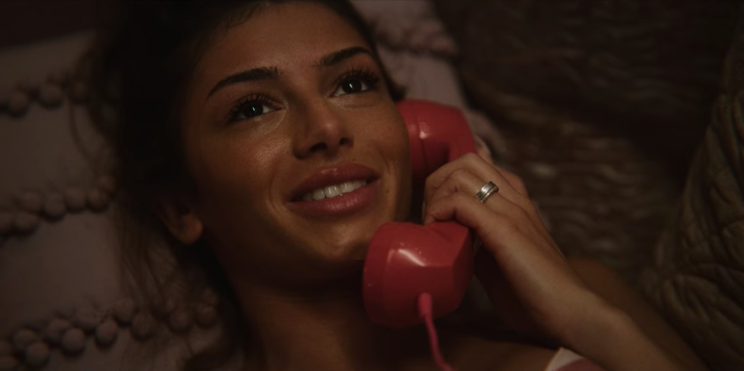 Ruby smiles while talking on the phone with Otis after he has met her dad. 